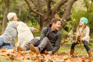 family outdoor playing in leaves